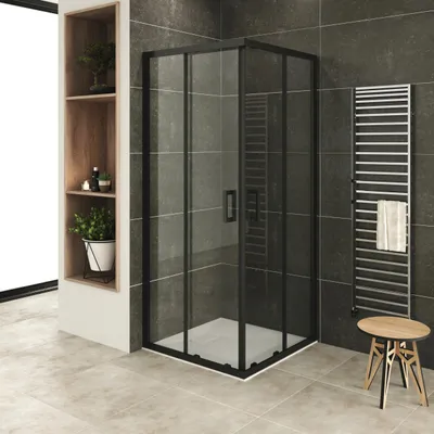 A modern bathroom with a black-framed glass shower enclosure, a towel rack, and a wooden stool.