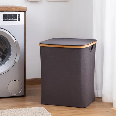 A laundry basket next to a washing machine in a laundry room.