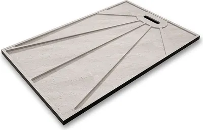 A rectangular shower tray with a stone-effect surface and a sunburst pattern etched into it. The tray has a black edge and a small oval cutout for drainage.