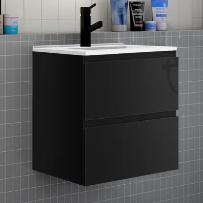 A black bathroom vanity with two drawers is mounted on a gray tiled wall.