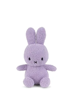 A lilac Miffy plush toy sitting on a white background.