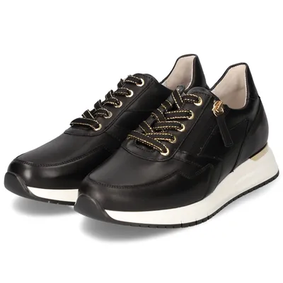 A pair of black leather sneakers with gold accents and white soles, presented on a white background.