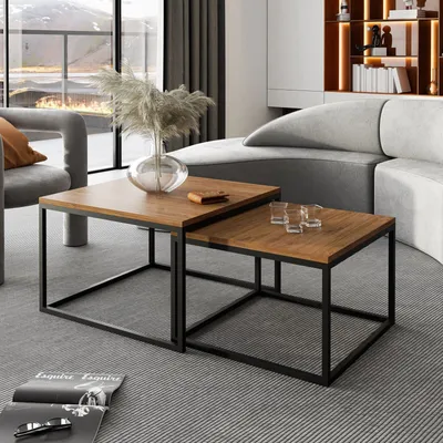 A living room scene with nesting coffee tables, a sofa, and a window view.
