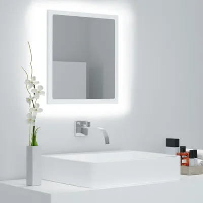 A modern bathroom sink with a faucet and a mirror with LED lighting.