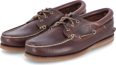 A pair of brown leather boat shoes on a white background.