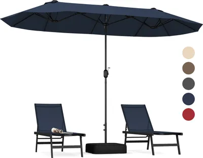 A navy blue double patio umbrella with two chairs and a base.