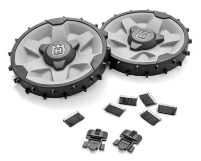 Two off-road wheels and several small brushes and clips are laid out on a white background.