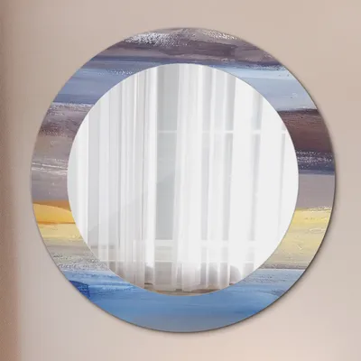 A round mirror with an abstract painting design around the edge, reflecting sheer white curtains.