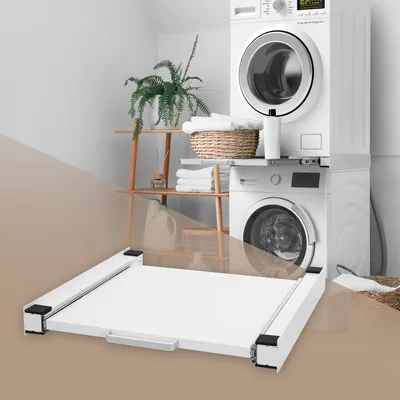 A laundry room scene with a washing machine and dryer stacked, a shelf with towels and plants, and a white pull-out frame in the foreground.