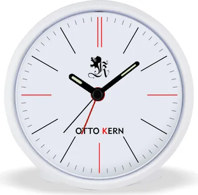 A close-up studio shot of a white analog alarm clock with a black and red design.