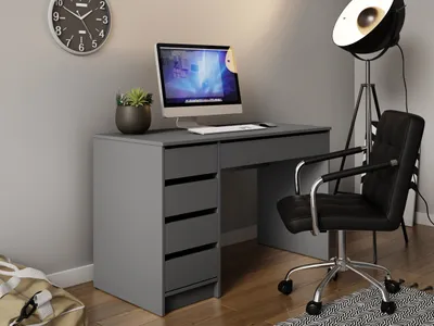 A modern desk setup with a computer, chair, and lamp.