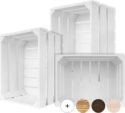 Three white wooden crates of varying sizes are arranged in a staggered formation against a white background. The crates are empty and show their slatted interior and exterior construction. Below the crates, there are four circular swatches representing dif