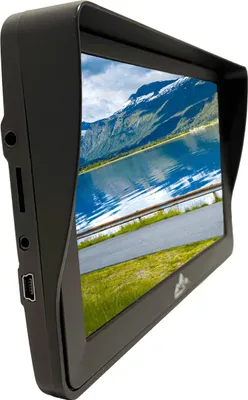 A side view of a black GPS device with a sunshade, displaying a scenic landscape on its screen.