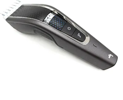 A close-up studio shot of a gray and black hair clipper against a white background.