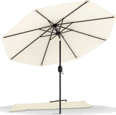 A beige patio umbrella with a black pole and frame, shown open against a white background. A beige protective cover lies on the ground beneath the umbrella.