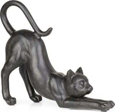 A dark-colored cat figurine stretching on a white background.