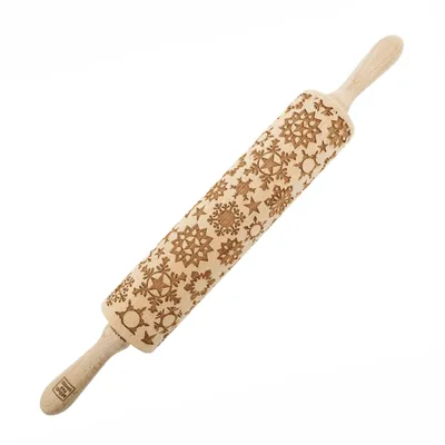 A wooden rolling pin with snowflake patterns carved into it, set against a white background.