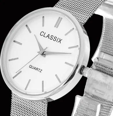 Close-up of a silver women's watch with a mesh band.