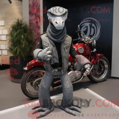 Immagine prodotto di Personaggio mascotte REDBROKOLY di un pitone grigio vestito con una giacca da motociclista e spille da scialle