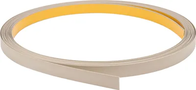 A roll of beige flat profile trim with adhesive backing, coiled on a white background.