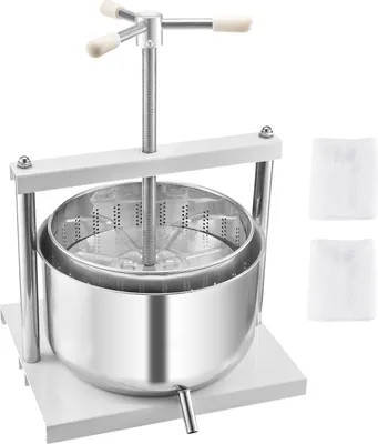 A stainless steel fruit and wine press with a white base and handles, shown against a white background. Two white cloths are placed to the right of the press.