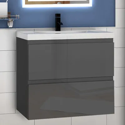 A modern bathroom vanity with a ceramic sink and a black faucet, set against a tiled wall and a blue background.