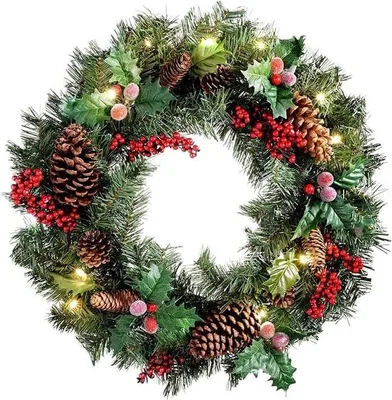 A Christmas wreath decorated with pine cones, red berries, and small lights, presented against a white background.