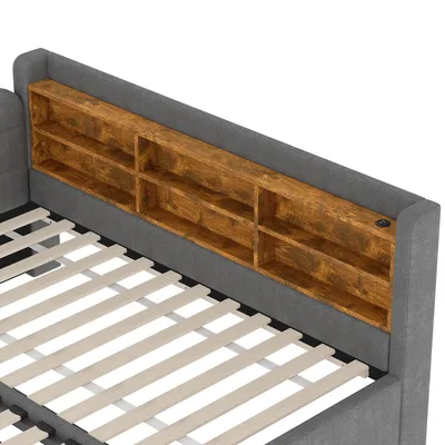 A close-up view of a bed frame with a built-in headboard shelf and a slatted base.