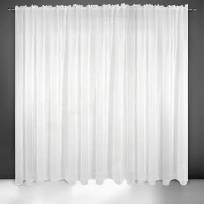 A white sheer curtain hanging against a dark gray wall and a white floor.