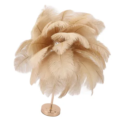 A decorative table lamp made of ostrich feathers on a metallic stand.