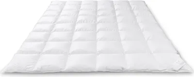 A white down comforter is laid out flat on a white background.