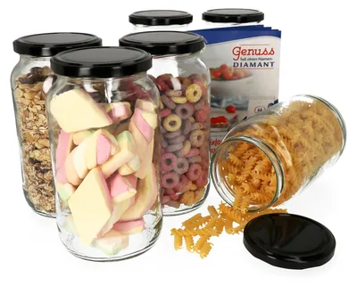 Several glass jars filled with food items and a bag of ingredients are arranged on a white background. One jar is tipped over, spilling pasta.