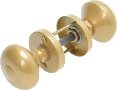A disassembled golden doorknob set with its internal mechanism is displayed against a white background.