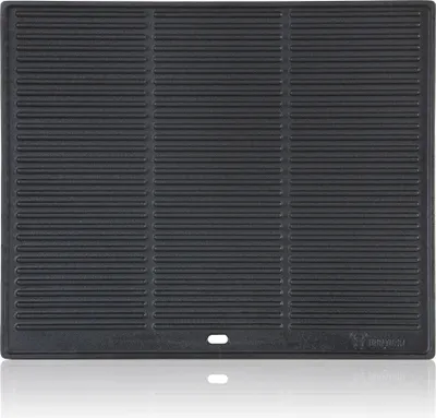 A black cast iron grill plate with horizontal ridges, shown from a top-down perspective with a slight reflection below.