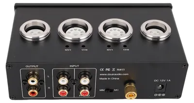 The back panel of a black electronic device, likely a phono preamplifier, is shown with various input and output connectors, regulatory markings, and branding.