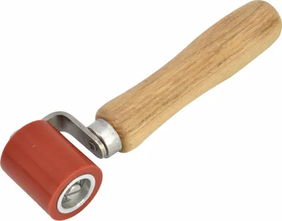 A close-up studio shot of a silicone printing roller with a wooden handle against a white background.