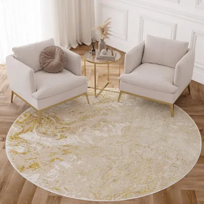 A living room scene with two armchairs and a round rug.