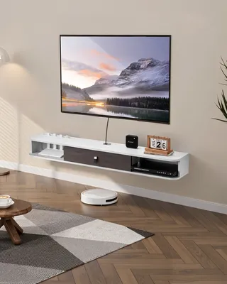 A modern living room with a wall-mounted TV stand and television.