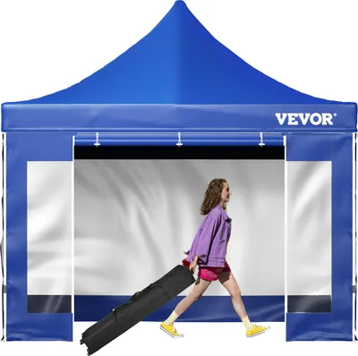 A woman is pulling a black bag with wheels through a blue tent.