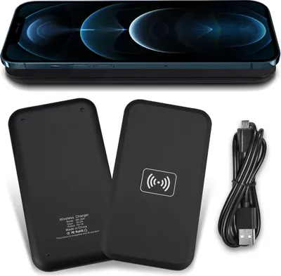 A flat lay of a wireless charger and its cable, with a smartphone placed on top of another wireless charger.