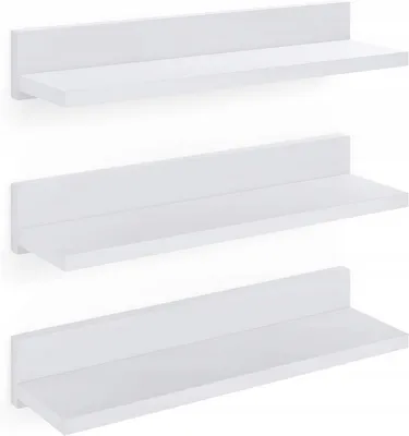 Three white floating shelves are mounted on a white wall, one above the other.