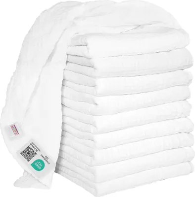 A stack of white muslin cloths with one cloth draped over the top, showing labels.