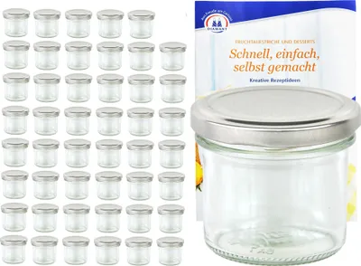 A collection of small glass jars with silver lids, alongside a booklet with text.