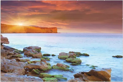 Produktbild von Wallario Wandbild Sonnenaufgang am Meer mit Landzunge und Felsen im Wasser, Größe: 61 x 91,5 cm, Poster mit rahmenlosen Bildhalter