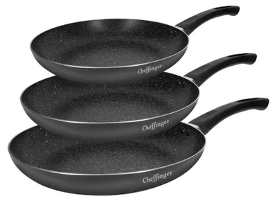 Three stacked frying pans with black handles and speckled gray interiors.