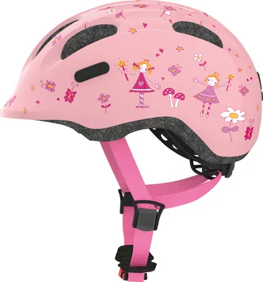 A pink children's helmet with fairy and mushroom decorations, shown from a side-angle.