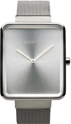 A close-up studio shot of a silver Bering watch with a square face and a mesh metal band.