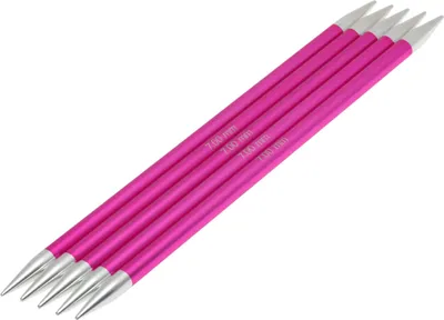 A set of five knitting needles on a white background.