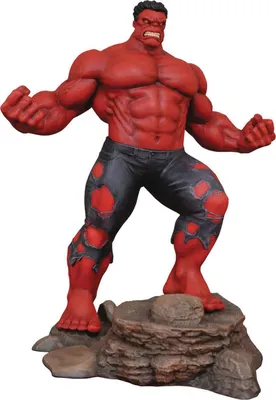 A statue of the Red Hulk character standing on a rocky base.