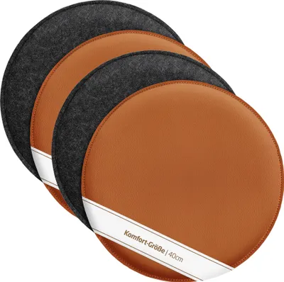 A set of four round reversible seat cushions, two with a brown faux leather side and two with a gray felt side, are stacked and angled on a white background.